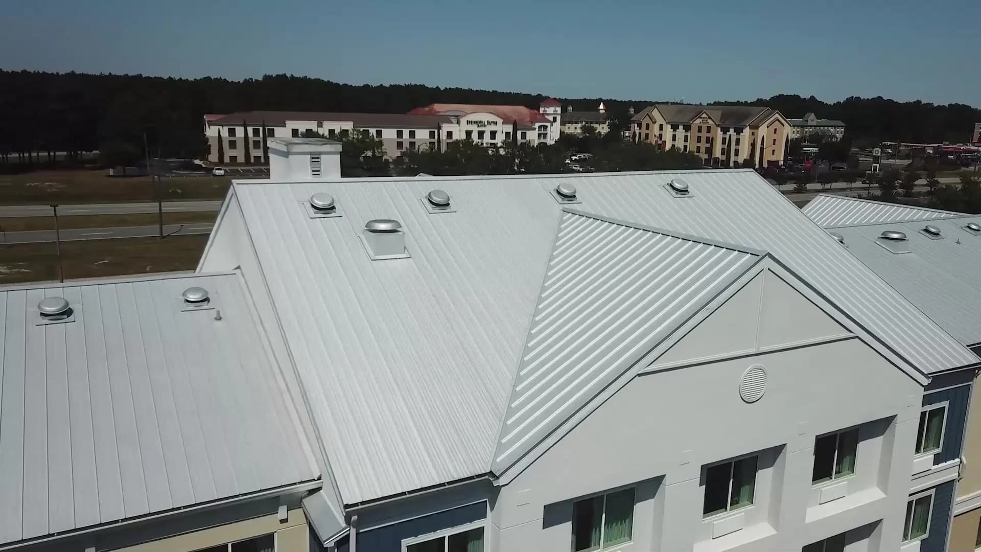 Aerial view of a standing seam metal roof on a commercial building